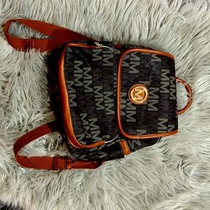 Brown traditional Micheal Kors purse backpack.